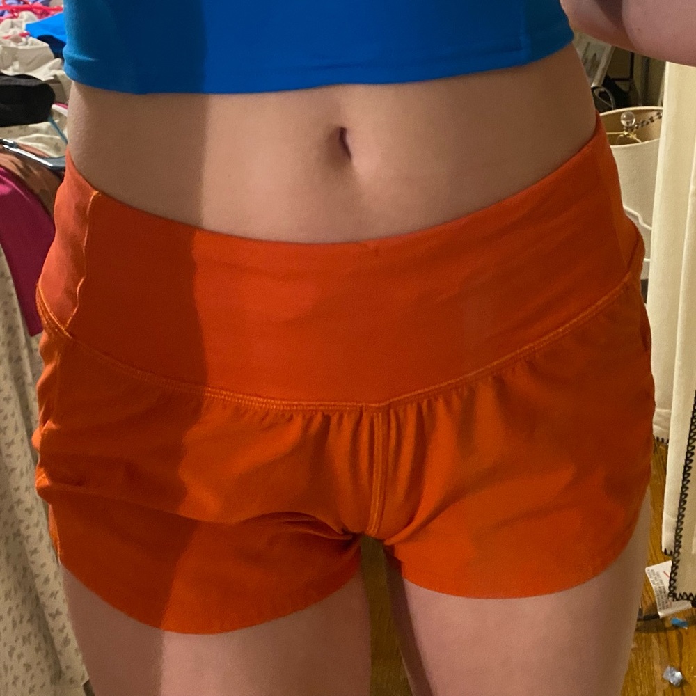 Red Lululemon speed up low rise shorts.